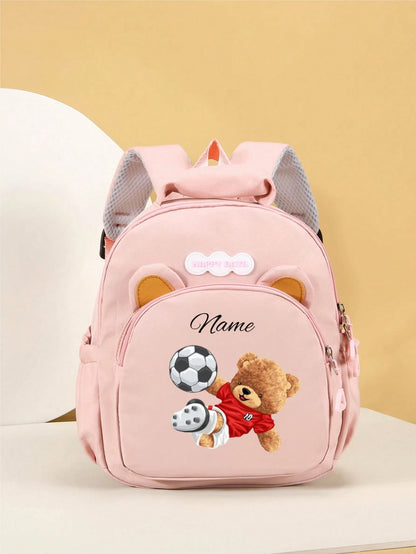 This Cute Cartoon Bear Kicking A Football Mini Customizable Backpack Features A Zipper Design, Can Be Hand-Held Or Adjustable Shoulder Strap Carried, Made Of Nylon Material. Suitable For Daily Use, Ou